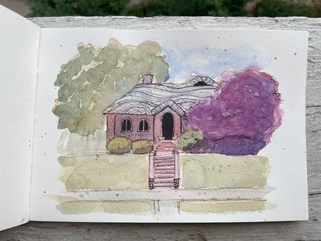 A watercolor and ink sketch of a small house. The house is a red brick with a wavy natural material roof. A large purple bush covers most of the house's right exterior, and a large green tree can bee seen behind the house. The house's entry points, the front door and two windows, are completely black blocking any view.