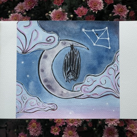 A watercolor painting of a sleeping bat, hanging from a crescent moon. The foreground swirls with blue and pink clouds. A celestial web is woven into the stars above the moon, and a lone spider nestles on it.