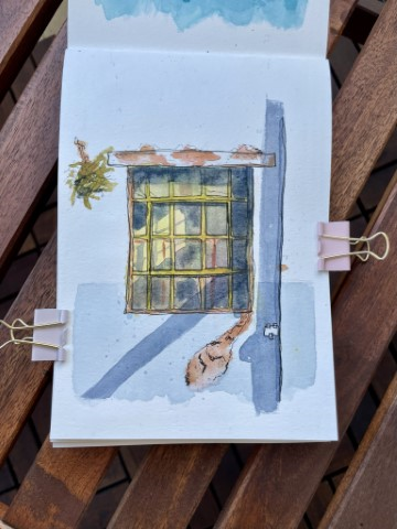 A watercolor and ink sketch of a rusted window with a harsh shadow cast across it.